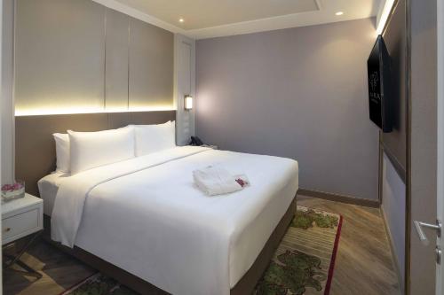Postel nebo postele na pokoji v ubytování Aira Hotel Bangkok Sukhumvit 11