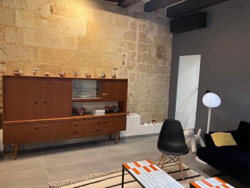 - un salon avec une armoire en bois et une chaise dans l'établissement Logement Quartier Historique Calme et Parking, à Tours