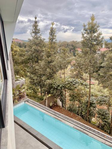 a swimming pool with a view of trees at Villa Morris By The Villas 100 in Cilama