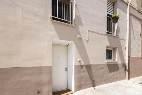 a white door on the side of a building at A casa di Edo in Matera