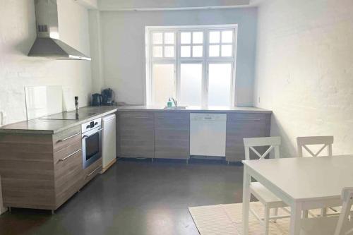 a kitchen with a table and a counter top at The old hardware store 3 bedroom in Aalborg