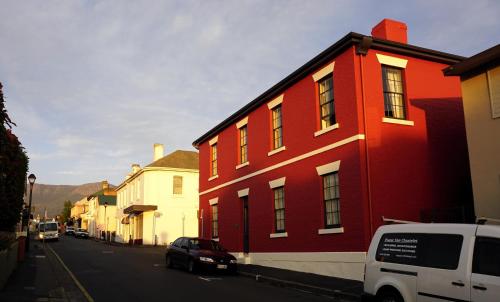 a red building on the side of a street at Grand Old Duke in Hobart