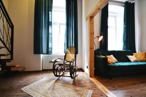 a living room with a wheelchair in front of a couch at Often-Hide Apartment in Częstochowa