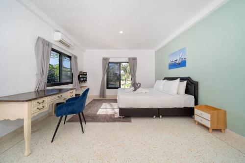 a bedroom with a desk and a bed and a desk and chair at Golden Sands Villa only 15 minutes walk to beach in Ban Lum Fuang