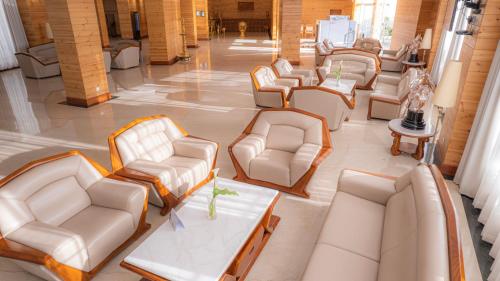 a row of chairs and tables in a waiting room at Araliya Red - Budget friendly Hotel- Where you find stunning 360 panoramic view of Nuwara Eliya in Nuwara Eliya