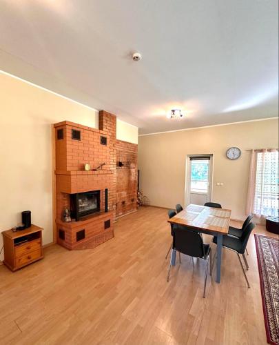 a living room with a table and a fireplace at Side Suvila in Palometsa