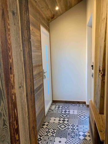 a hallway with a door and a tile floor at Le Mirador chalet Seytroux, big views 15 minutes from Morzine in Seytroux