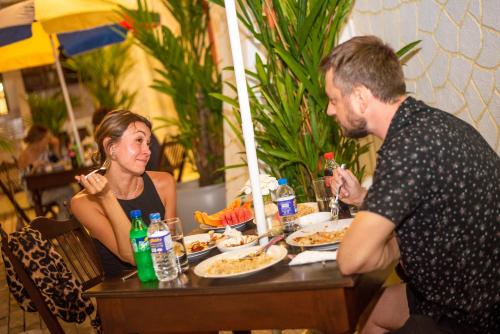 a man and a woman sitting at a table eating food at Cara Galle Fort in Galle