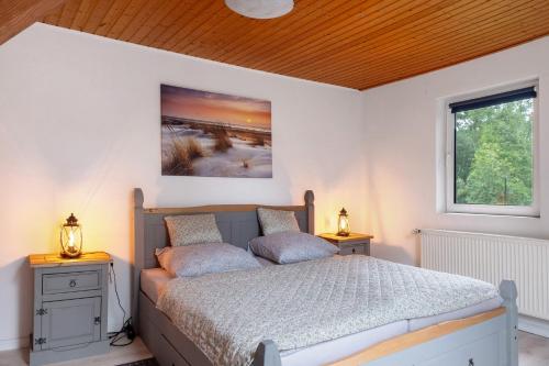 a bedroom with a bed with two pillows on it at Grodenhof in Norderschwei