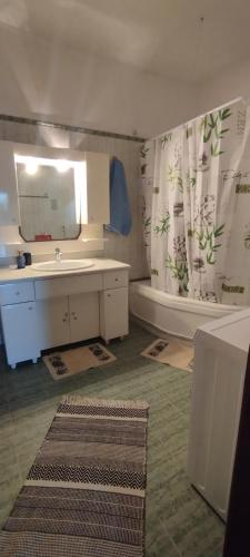 a bathroom with a sink and a mirror and a tub at Josephine's House in Neochórion