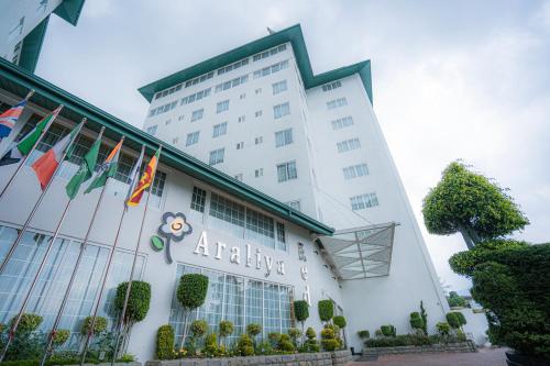 an office building with flags in front of it at Araliya Red - Budget friendly Hotel- Where you find stunning 360 panoramic view of Nuwara Eliya in Nuwara Eliya