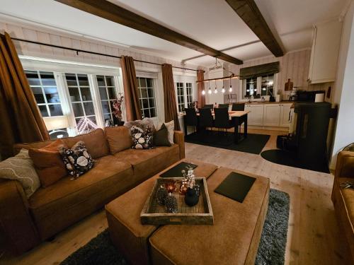 a living room with a couch and a table at Gaustatoppen View Apartment in Gaustablikk