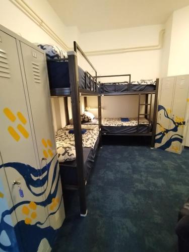 a room with three bunk beds in it at Hostel Koprivnica in Koprivnica