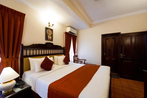 a bedroom with a large bed in a room at Hotel Arches in Cochin
