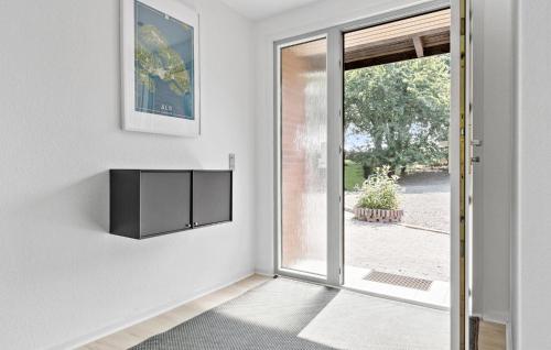 a living room with a door open to a patio at Awesome Home In Nordborg With Wifi in Nordborg