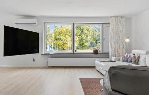 a white living room with a large window and a couch at Awesome Home In Nordborg With Wifi in Nordborg