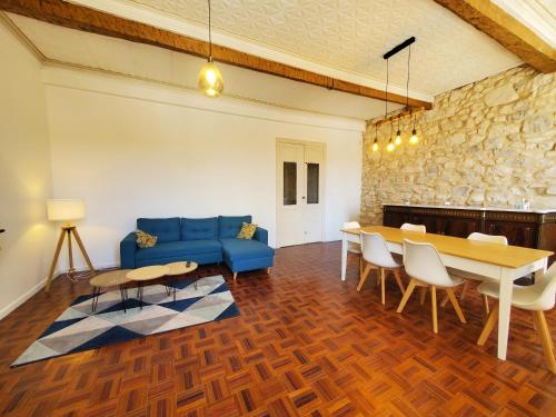 un salon avec un canapé bleu et une table dans l'établissement La Via Domitia - Belle Maison de maître, à Portel-des-Corbières