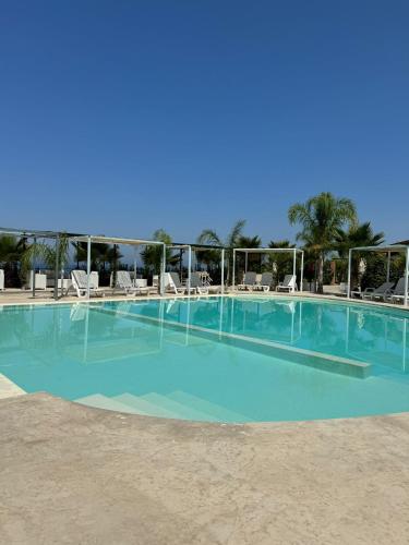 a large swimming pool with blue water at L'oasi del Tuffatore in Agropoli