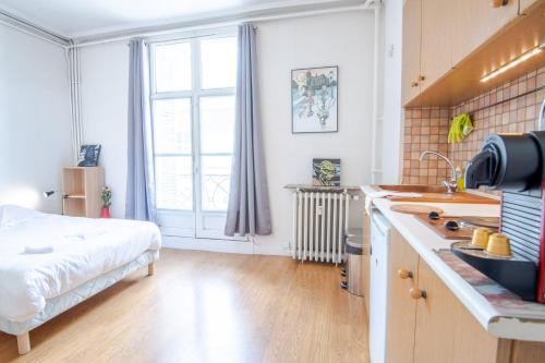 - une cuisine avec un lit et un évier dans la chambre dans l'établissement Le Petit Emile Zola, à Tours