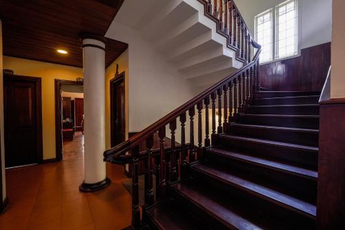 a spiral staircase in a building with a window at Hotel Arches in Cochin