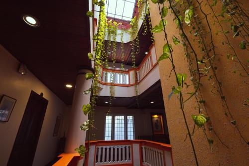 a spiral staircase in a building with plants at Hotel Arches in Cochin