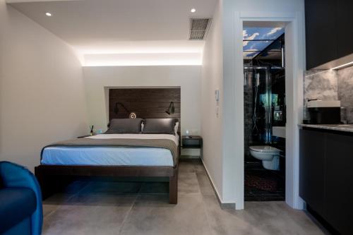 a bedroom with a bed and a bathroom at Sylvia Camping & Luxury Suites, Panel Hospitality Homes & Villas in Litochoro
