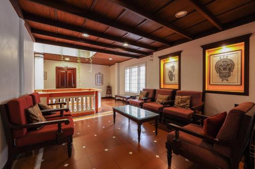 a living room with couches and a table at Hotel Arches in Cochin