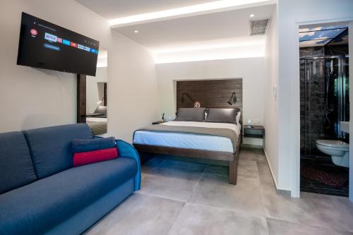 a bedroom with a bed and a couch at Sylvia Camping & Luxury Suites, Panel Hospitality Homes & Villas in Litochoro
