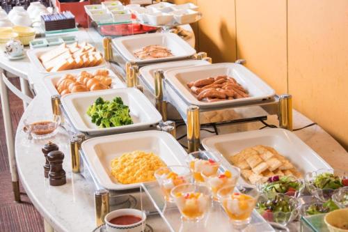 a buffet with trays of food on a table at Diamond Hotel Tokyo in Tokyo