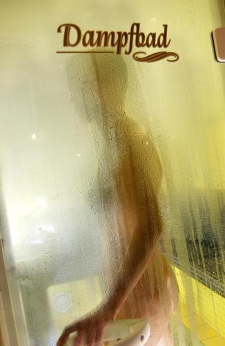a glass window with a persons reflection in it at Hotel Flatscher in Stuhlfelden