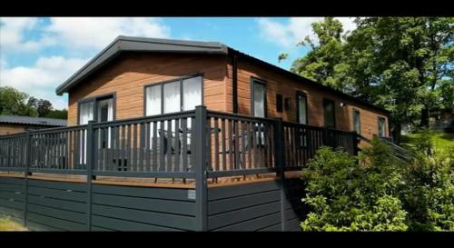 a house with a balcony and a fence at 30 Golf View in Jedburgh