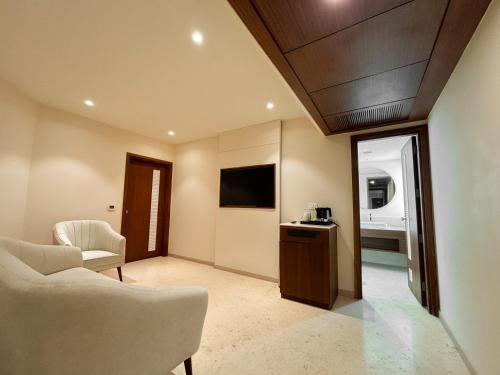 a living room with a couch and a tv at Best Western Plus Amritsar in Amritsar