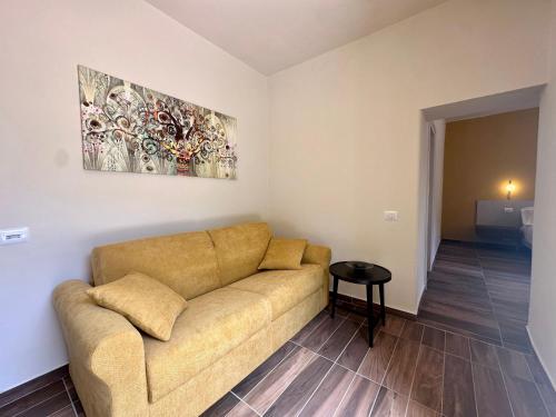 a living room with a couch and a painting on the wall at La Ninfa Hotel in Bagni di Lucca