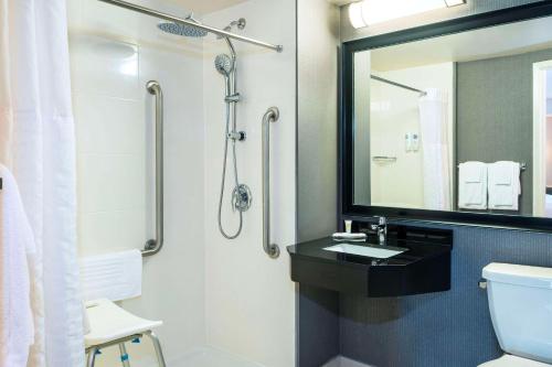 a bathroom with a sink and a shower at Comfort Inn in Newmarket