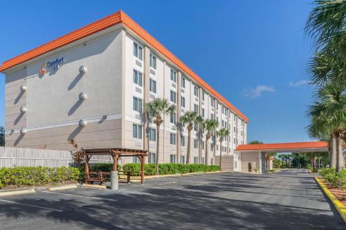 a large white building with an orange roof at Comfort Inn St Petersburg North in St. Petersburg