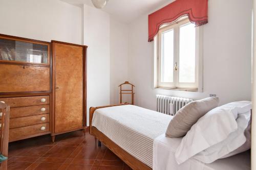 a bedroom with a bed and a dresser and a window at Casa Salento tre R - Lecce Selection in Squinzano