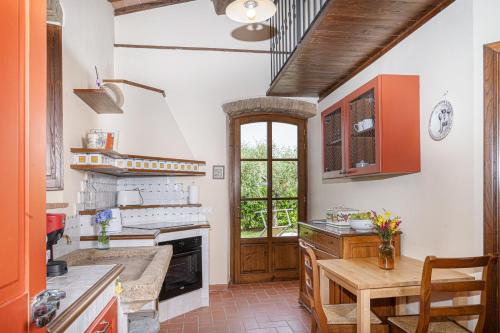 a kitchen with a table and a fireplace at La Capanna di Montauto in San Gimignano