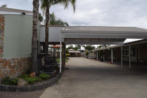 an empty building with awning next to a street at Barooga River Gums Motor Inn in Barooga