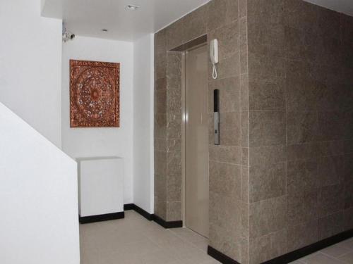 a bathroom with a shower with a painting on the wall at Baan Nan Hotel in Nan