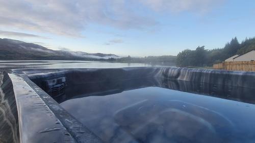 a large pool of water in a body of water at Shoreland Lodges - Holly Lodge in Fort Augustus