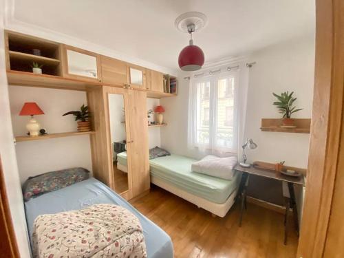 a bedroom with a bed and a desk and a window at Mosaic Villagee -15 mn transport to Champs Élysées in Nanterre