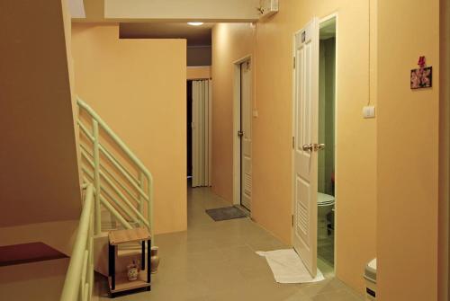 a hallway with a stairway leading to a bathroom at Salika Hostel Patong Phuket in Patong Beach