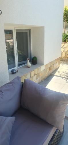 a large purple couch sitting on a patio at Къща за гости Ози in Ovchartsi