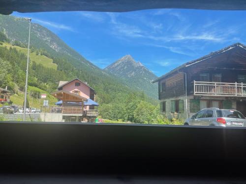 a view of a mountain from a window of a building at Raccard rénové in Orsières
