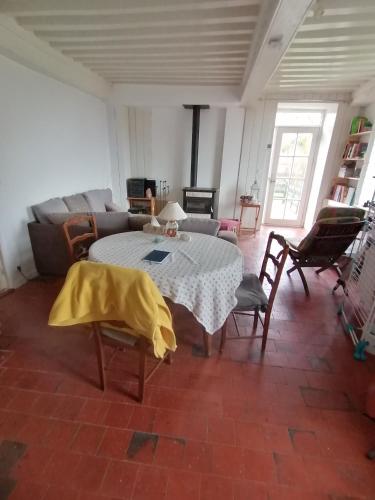 a living room with a table and a couch at Natur und Sterne in Arleuf