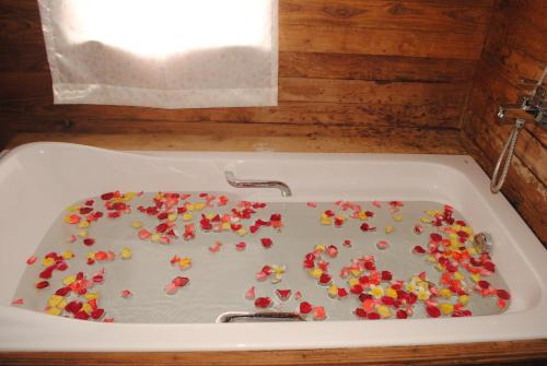 a bath tub filled with candy in a sink at Golden Island Cottages Thale U Hotel in Ywama