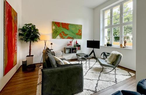 a living room with a couch and a table at Lunas Appartements in der alten Schule Essen in Essen
