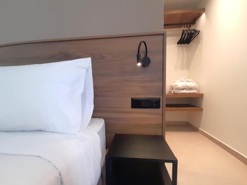 a bedroom with a bed and a small table next to it at Elite Centre in Rhodes Town