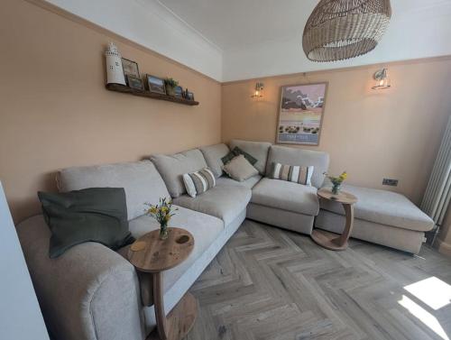 a living room with a couch and a table at Kemp's Kottage in Lowestoft