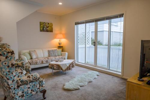 a living room with a couch and a window at Bolton Executive Residence in Wellington